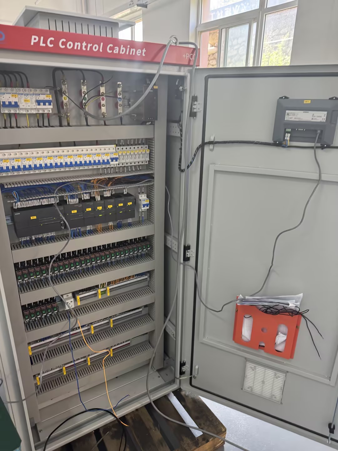 PLC control cabinet with I/O modules and internal wiring for wastewater treatment automation